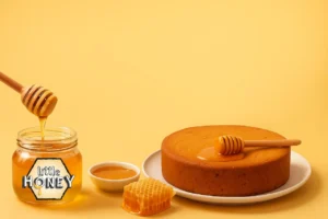 A jar of Little Honey drizzled over a slice of cake, showing how honey brings rich flavor and natural sweetness to every dessert.