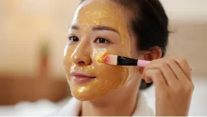 Woman applying a honey face mask for skin whitening, using honey for skin whitening to achieve a natural glow.