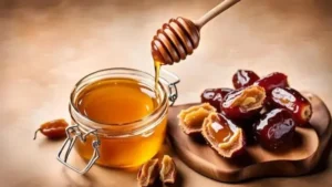 A wooden dipper drizzles golden honey into a glass jar next to a pile of fresh fruit, embodying Natural Wellness with Honey & Ajwa Dates.