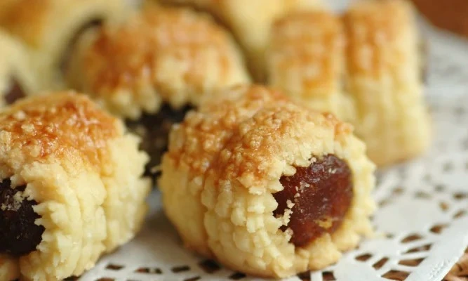 Freshly baked pineapple tarts on a plate showcasing delicious Festive Kueh Recipes for celebrations
