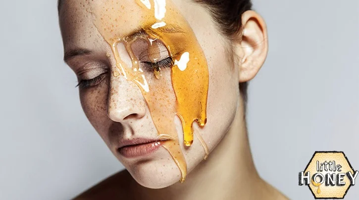 Honey for skin whitening – woman with raw honey dripping on face for natural glow