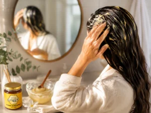 Woman applying a natural scalp treatment using pure honey for dandruff relief.